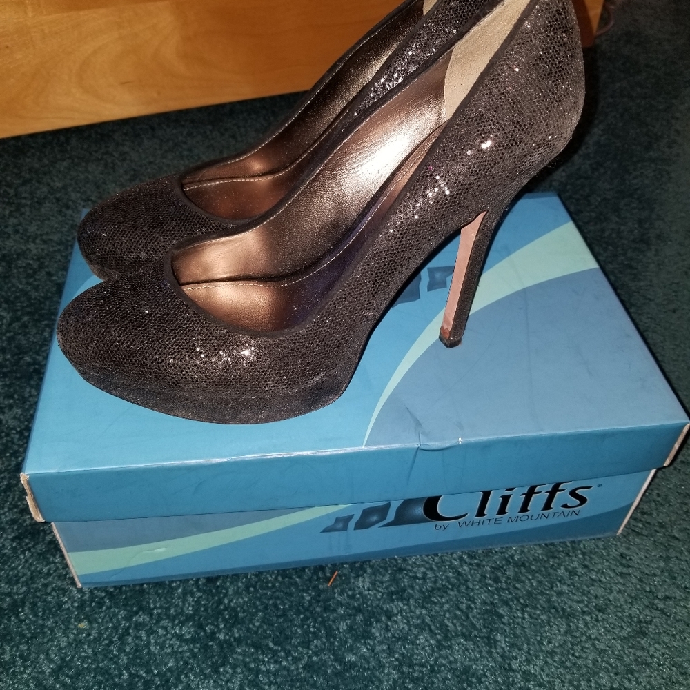 Black sparkly heels cliffs by white mountain